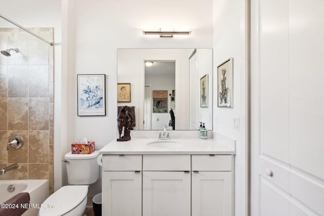 full bathroom with vanity, tiled shower / bath, and toilet