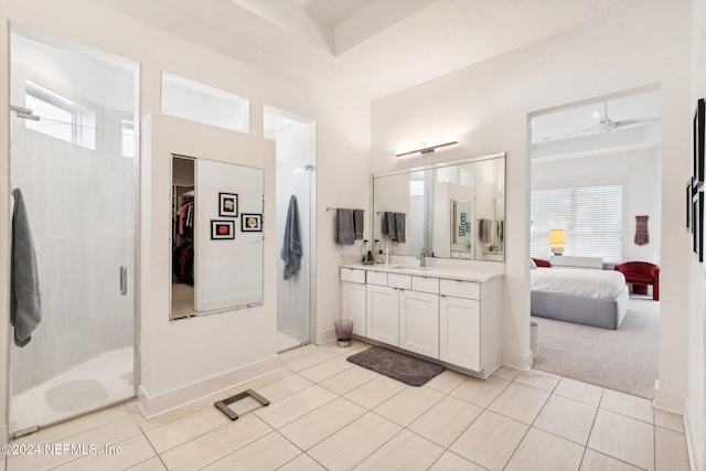 bathroom with tile patterned floors, an enclosed shower, vanity, and a wealth of natural light