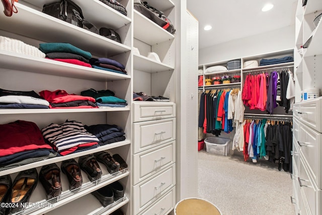 walk in closet with carpet