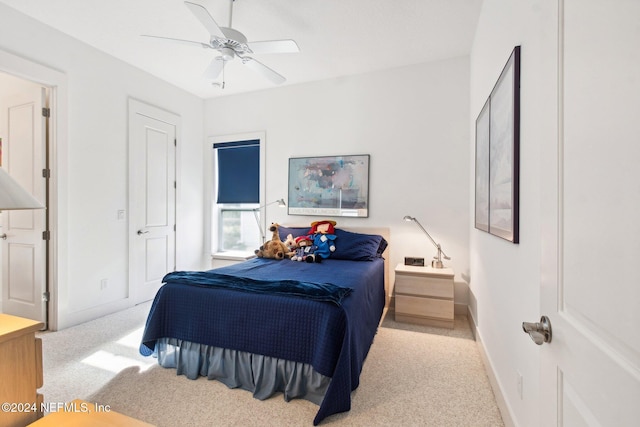 bedroom with light carpet and ceiling fan