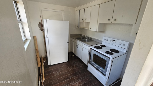 kitchen with white cabinets, dark hardwood / wood-style floors, white appliances, and sink