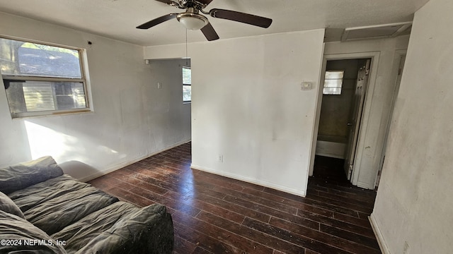 unfurnished living room with ceiling fan and dark hardwood / wood-style flooring