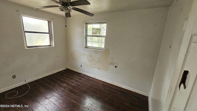 spare room featuring ceiling fan and dark hardwood / wood-style flooring