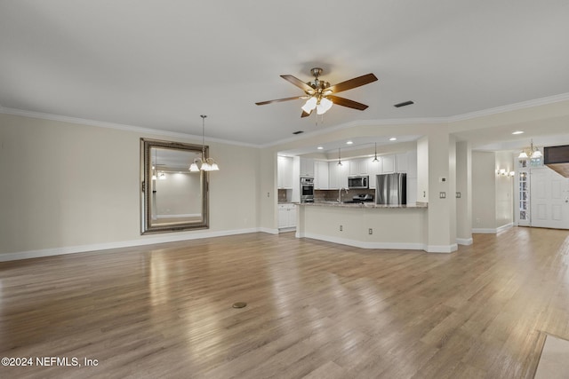 unfurnished living room featuring light wood-style floors, ornamental molding, and ceiling fan with notable chandelier