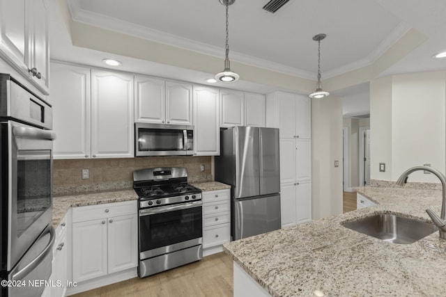 135 N Champions Way Unit 212, Saint Augustine, FL 32092 - kitchen with stainless steel appliances, ornamental molding, white cabinets, and recessed lighting