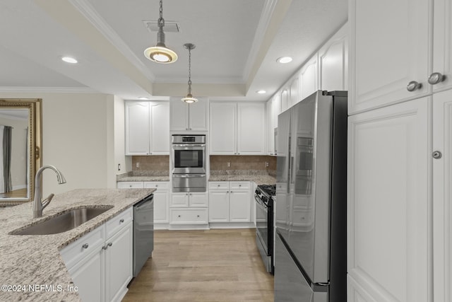 135 N Champions Way Unit 212, Saint Augustine, FL 32092 - kitchen featuring appliances with stainless steel finishes, ornamental molding, a raised ceiling, white cabinetry, and recessed lighting