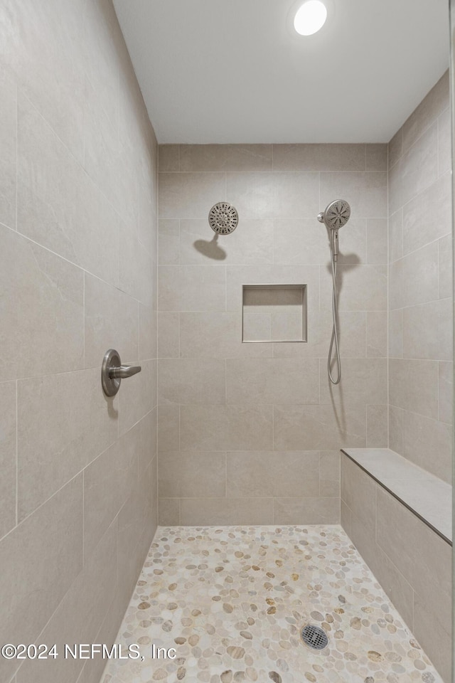 bathroom with a tile shower