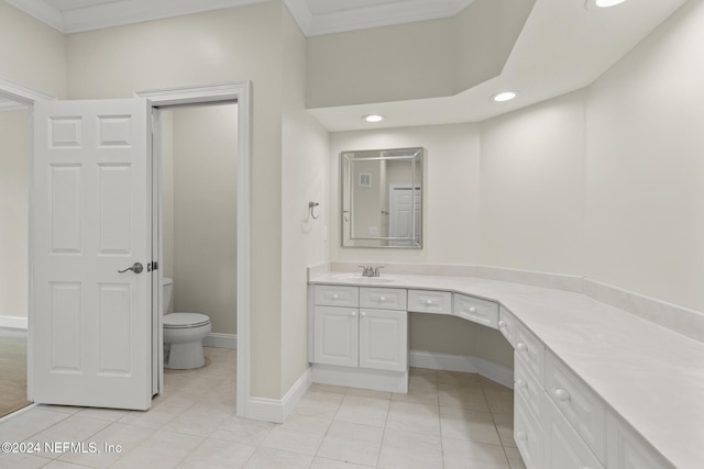 bathroom with crown molding, toilet, vanity, tile patterned flooring, and baseboards