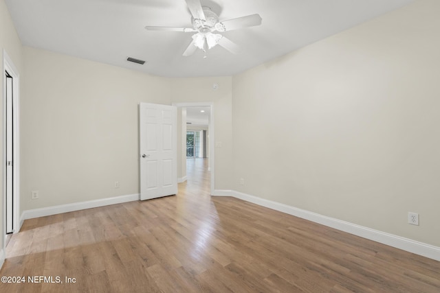 unfurnished bedroom with ceiling fan, light wood finished floors, visible vents, and baseboards