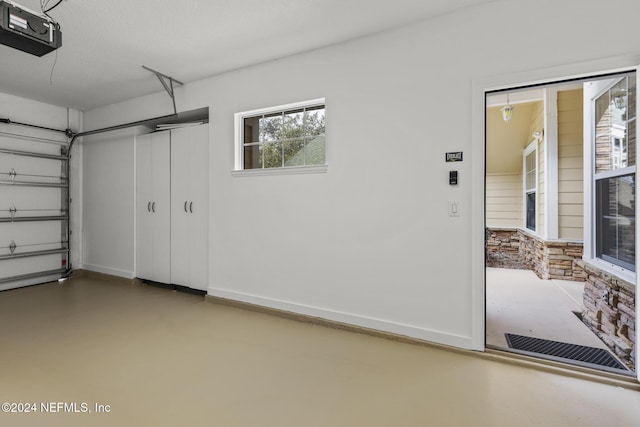 garage featuring baseboards and a garage door opener