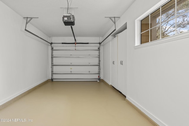 garage with a garage door opener and baseboards