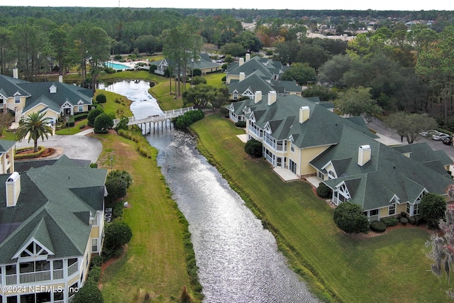 birds eye view of property featuring a water view and a residential view