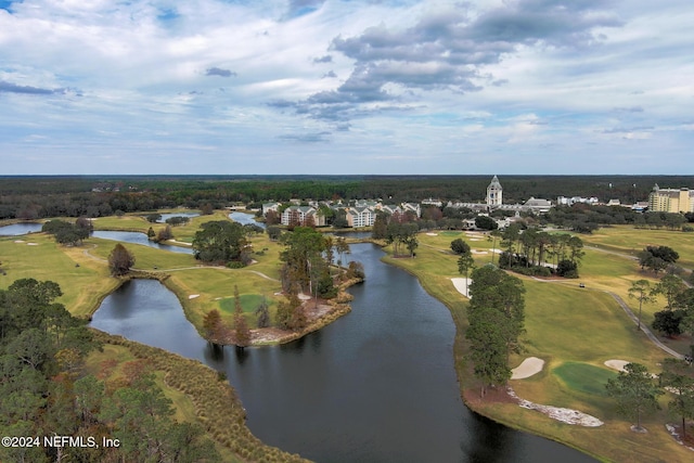 birds eye view of property with view of golf course and a water view