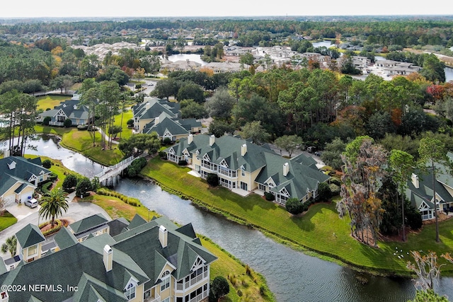 drone / aerial view featuring a water view and a residential view