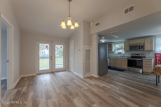 206 Citizen St, Green Cove Springs, FL 32043 - kitchen with french doors, hanging light fixtures, stainless steel appliances, a chandelier, and light wood-type flooring