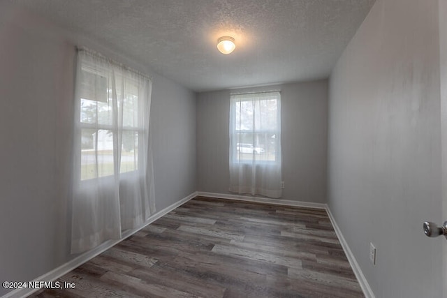 206 Citizen St, Green Cove Springs, FL 32043 - unfurnished room with a textured ceiling and dark hardwood / wood-style floors