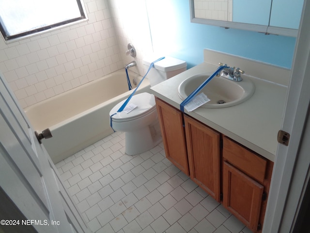 full bathroom featuring tile patterned flooring, vanity, toilet, and tiled shower / bath