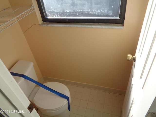 bathroom with toilet and tile patterned floors