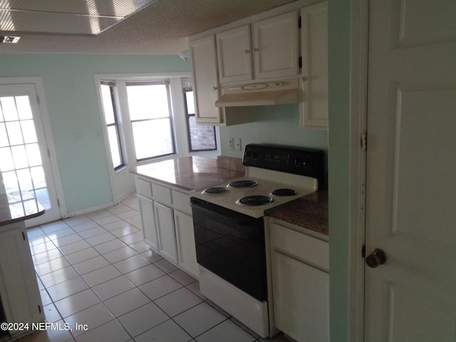 kitchen with white cabinetry, white range with electric cooktop, and light tile patterned flooring