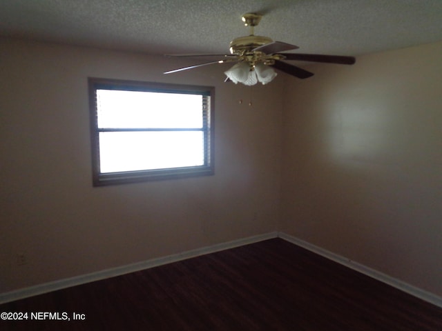 spare room with ceiling fan, wood-type flooring, and a textured ceiling