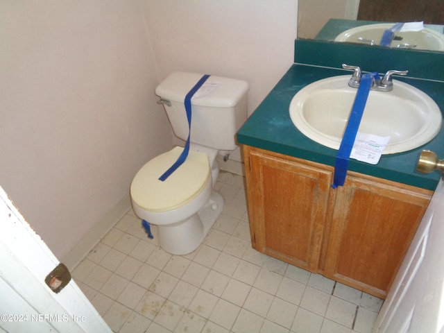 bathroom featuring tile patterned floors, vanity, and toilet