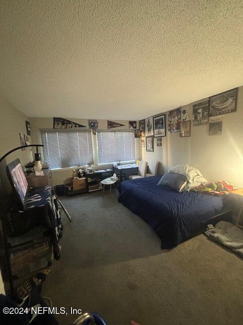 carpeted bedroom with a textured ceiling