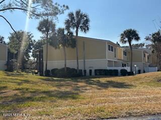 view of side of property with a lawn