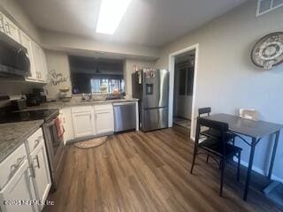 kitchen featuring appliances with stainless steel finishes, dark hardwood / wood-style floors, and white cabinets