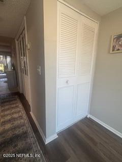 corridor featuring dark wood-type flooring