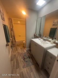 bathroom with vanity, hardwood / wood-style floors, and toilet