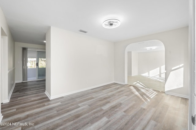 spare room with wood-type flooring