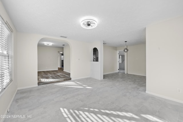 spare room featuring a textured ceiling