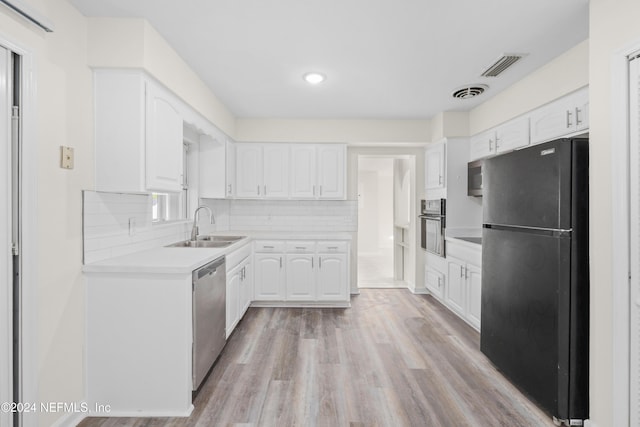 kitchen with white cabinets, sink, light wood-type flooring, and stainless steel appliances