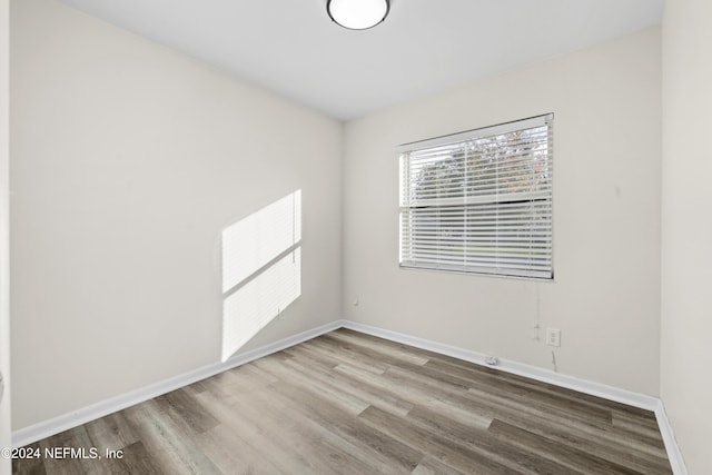 empty room with hardwood / wood-style flooring