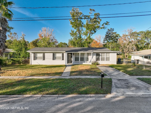 ranch-style home with a front lawn