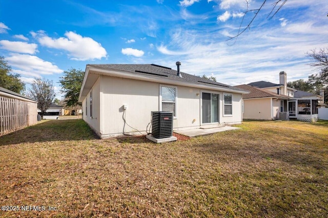 back of house with a yard and central AC unit