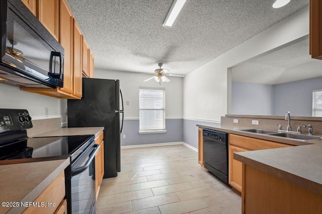 kitchen featuring ceiling fan, sink, and black appliances