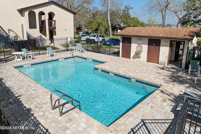 view of pool with an outdoor structure and a patio