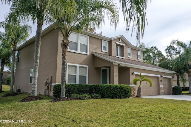 view of front of house featuring a garage and a front lawn