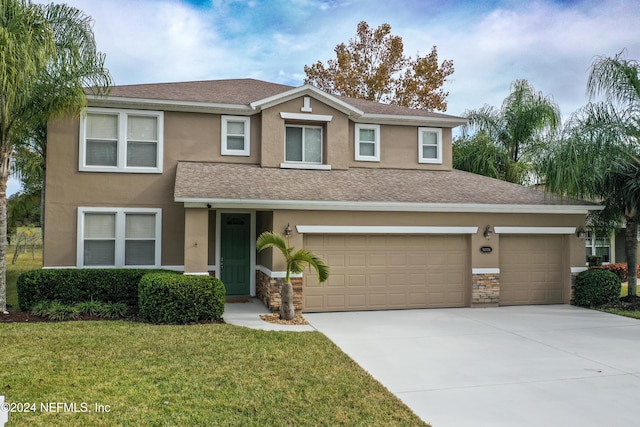 view of front of home featuring a garage and a front lawn