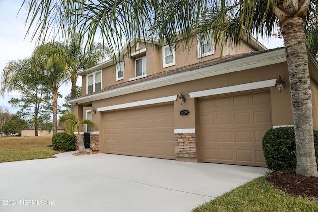 view of front of property with a front yard and a garage