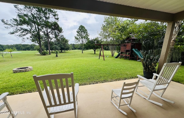 view of patio / terrace featuring a playground and an outdoor fire pit