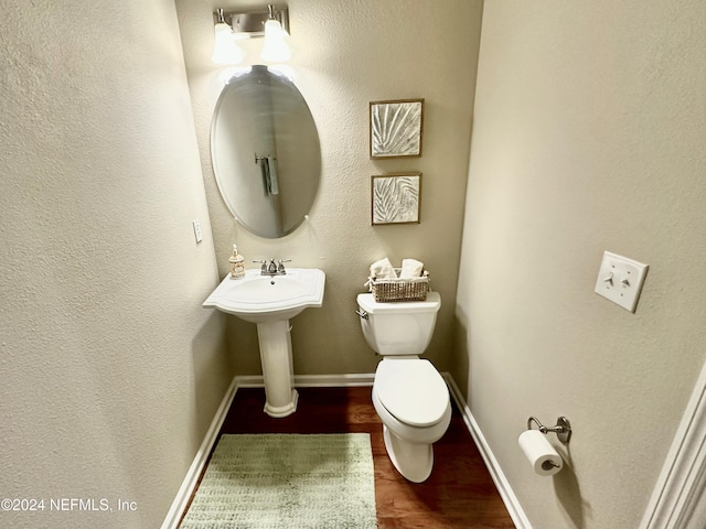 bathroom with toilet and hardwood / wood-style flooring