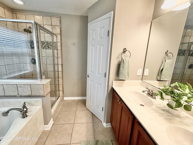 bathroom with tile patterned flooring, vanity, and separate shower and tub