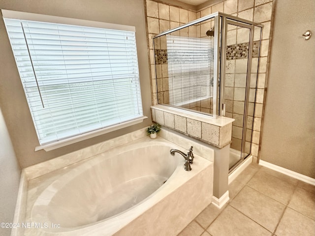 bathroom featuring tile patterned flooring and separate shower and tub