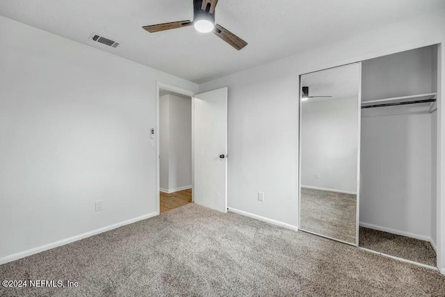 unfurnished bedroom with carpet flooring, ceiling fan, and a closet