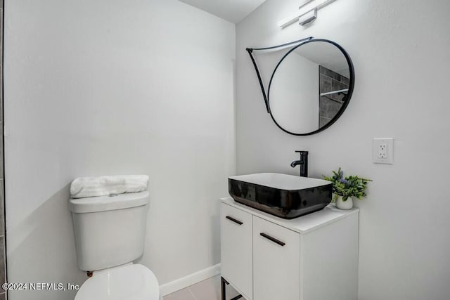 bathroom with tile patterned floors, vanity, and toilet