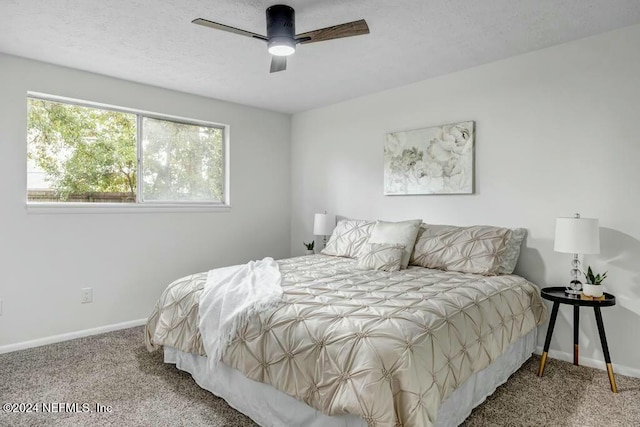 bedroom featuring multiple windows, ceiling fan, and carpet floors