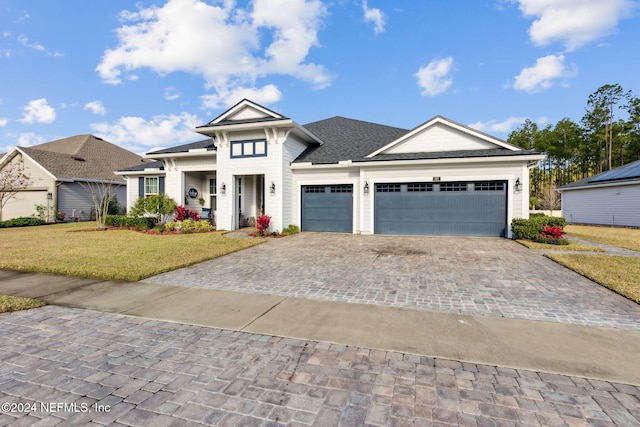 view of front of property featuring a garage and a front yard