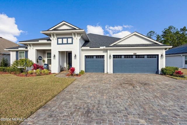 view of front of home with a garage and a front yard